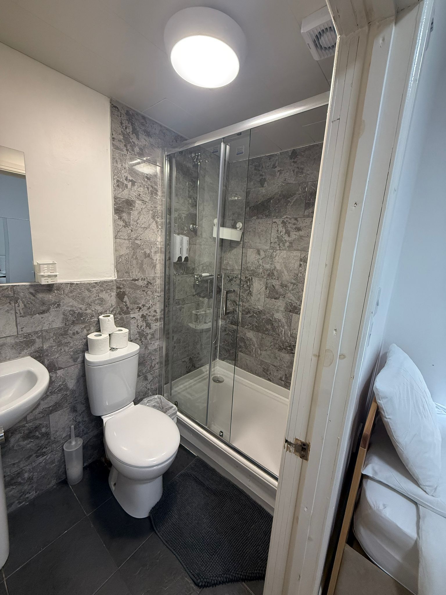 Shower, hair dryer, towels, toilet paper