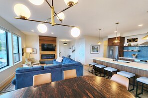 A modern kitchen with a central island, bar stools, and a built-in oven. - Stunning Ocean View! Pet Friendly! Shell Street Lookout (Yachats)