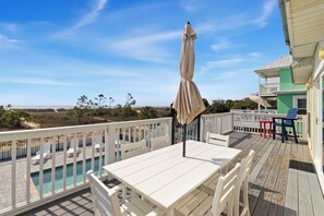 A deck with a pool, white furniture, and a view of the beach. - NEW LISTING! A License to Chill, 4BD/3BA gulf front w/panoramic views, private pool, pet friendly! (Port St. Joe)