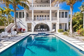 A heated pool - Kingfish House: Luxury Canal Home, Boat Dock, Pool, Spa by Anna Maria Life Vacation Rentals (Anna Maria)