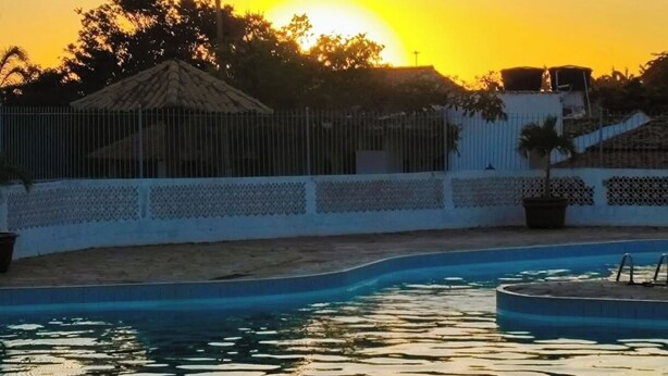 A swimming pool with a sunset in the background. - CostaeCunhaIpe104  (Iguaba Grande)