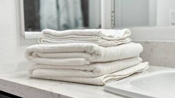 Secadora de cabello, toallas, jabón, papel de baño