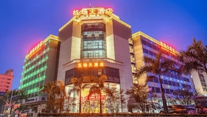 A hotel with a prominent sign at the top, multiple floors, and a well-lit facade. - Shenzhen Airport Hotel Bao'an Airport  (Shenzhen)