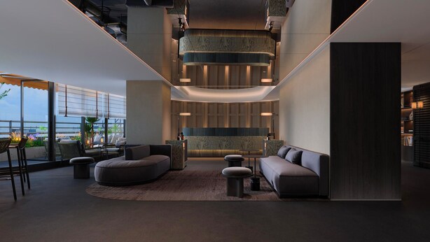 Un espace de détente moderne avec des sièges disposés en arc de cercle, une table basse centrale et une vue sur l’extérieur grâce à de grandes fenêtres.