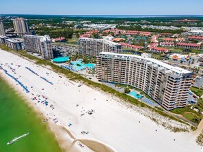 A coastal resort with multiple high-rise buildings, a sandy beach, and a large swimming pool. - Edgewater Golf Villas | Family Friendly 2BR Near Beach (Panama City Beach)