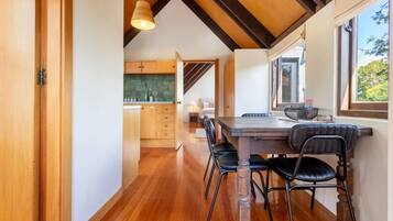 A modern kitchen with wooden cabinets and a large window.