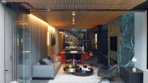A modern living room with a sofa, chairs, a coffee table, and a fireplace. - Luxury Paddington Townhouse (Darlinghurst)