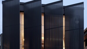 A modern building with a dark facade and vertical slats. - Luxury Paddington Townhouse (Darlinghurst)