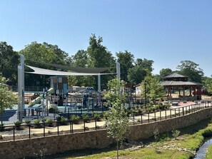 A playground with various play structures, a covered seating area, and a small pavilion. - Stylish | Pvt Baths | Minutes to Shopping & Dining (Anderson)