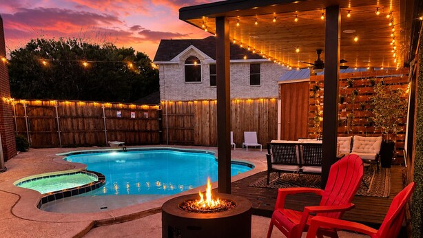 A backyard with a swimming pool, red chairs, a fire pit, and string lights. - FIFA2026, Pool + FREE Heated Spa, ATTstadium, Six Flag (Grand Prairie)