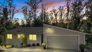 A two-story house with a garage, surrounded by trees and a sunset sky. - Aptos Hills Getaway - Welcome to Oak Landing (Aptos)