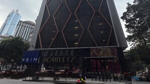 A tall building with a geometric facade and a sign for 'Scarlett'. - Metahome@Scarletz Suites KLCC (Kuala Lumpur)