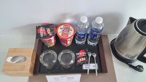 Una bandeja con productos Nescafé, botellas de agua y una cafetera.