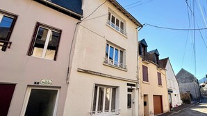 A row of residential buildings with a street in front. - Alpine Sanctuary by the Market Lane (Mont-Dore)