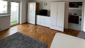 A modern apartment with a living area, kitchen, and a balcony. - Perfect for City Break (Warsaw)