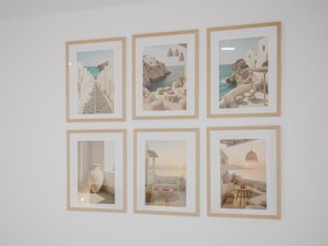 Six œuvres d’art encadrées sont accrochées au mur.