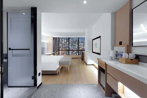 A modern hotel room with a city view, a bed, a desk, and a kitchenette. - come and stay at S Hotel（Chongqing Jiefangbei Store ） (Chongqing)
