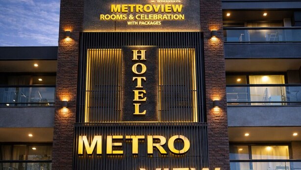 A hotel named 'METROVIEW' with a modern design, featuring a reception area and multiple balconies. - metroview rooms & celebration (New Delhi)