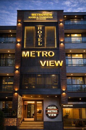 A hotel named 'METROVIEW' with a modern design, featuring a reception area and multiple balconies. - metroview rooms & celebration (New Delhi)