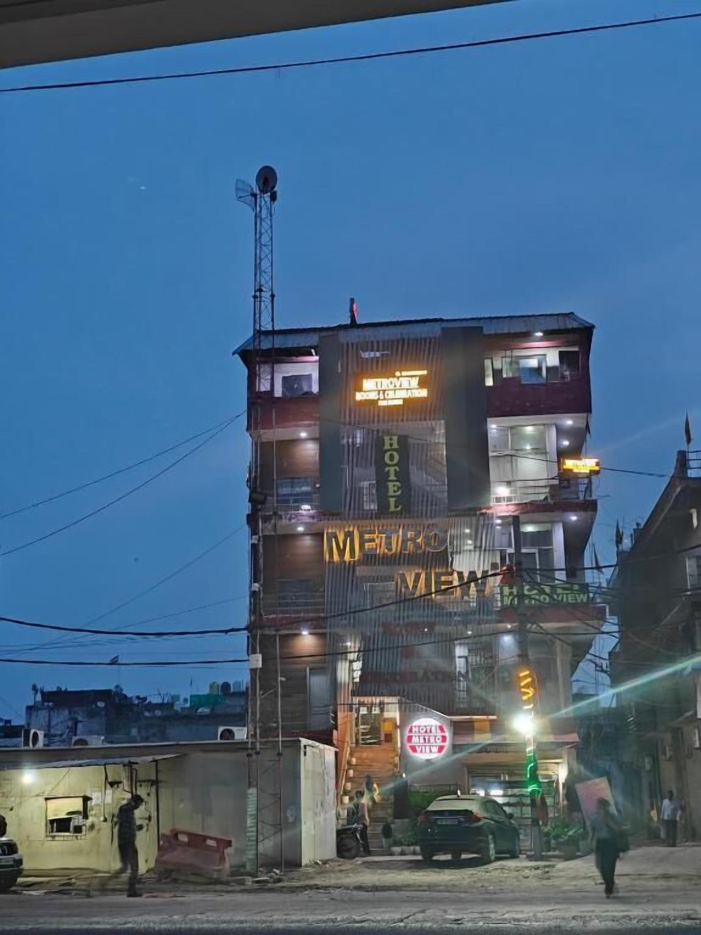A multi-story building with a sign for "HOTEL METRO VIEW."