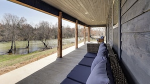 A covered outdoor seating area with a view of a river and trees. - Cossatot River Retreat: Home w/ Fire Pit & Grill (Gillham)