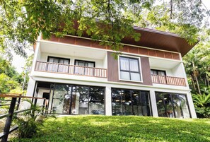 A two-story building with a balcony, large windows, and a well-maintained lawn. - Uno Maya by Araw Residences (Nasugbu)