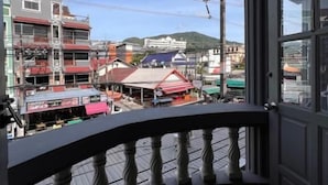 A balcony with a view of buildings and power lines. - Patong Adventure Hostel (Patong)