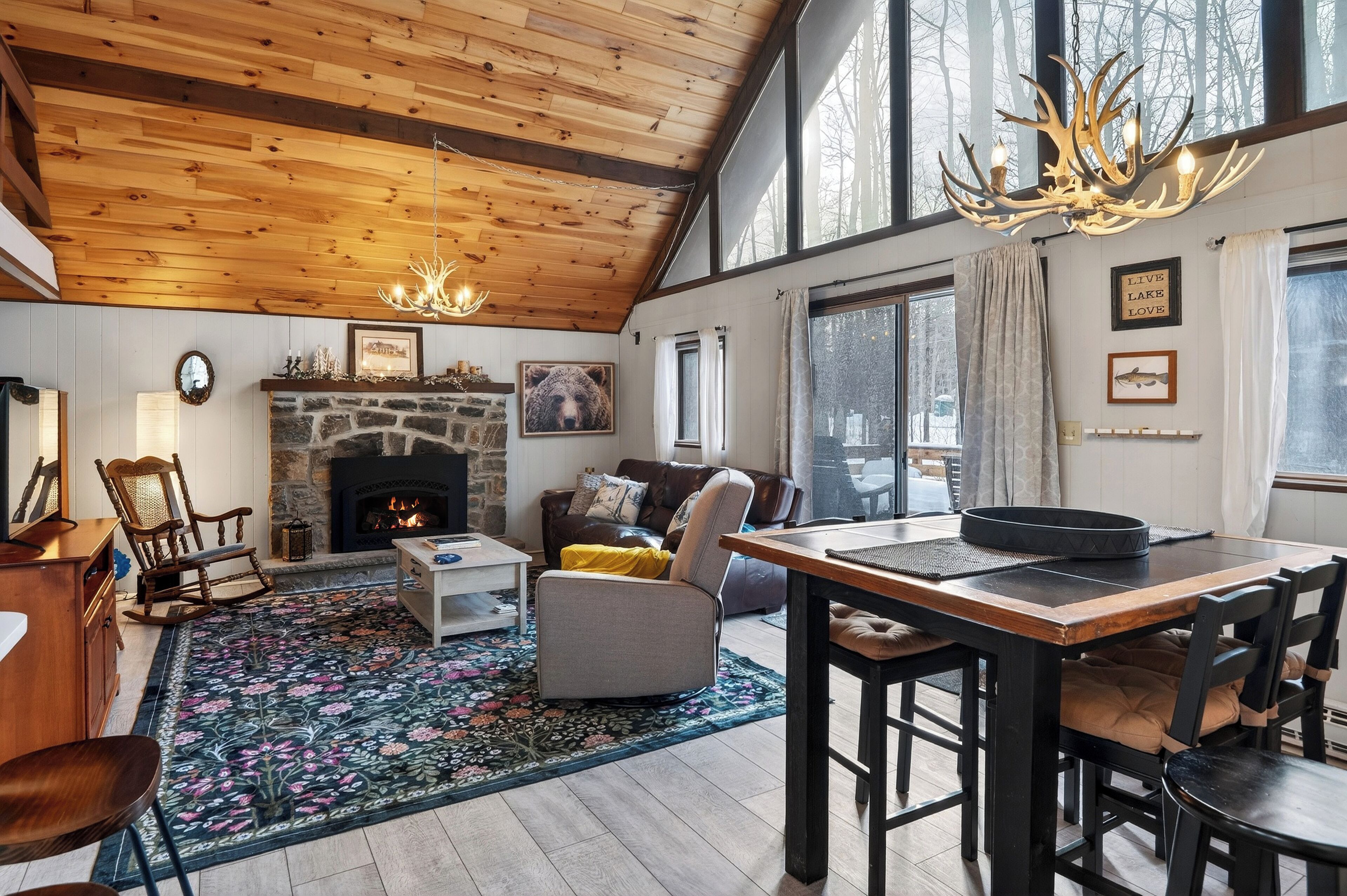 Warm and inviting open-concept living area with a stone fireplace.