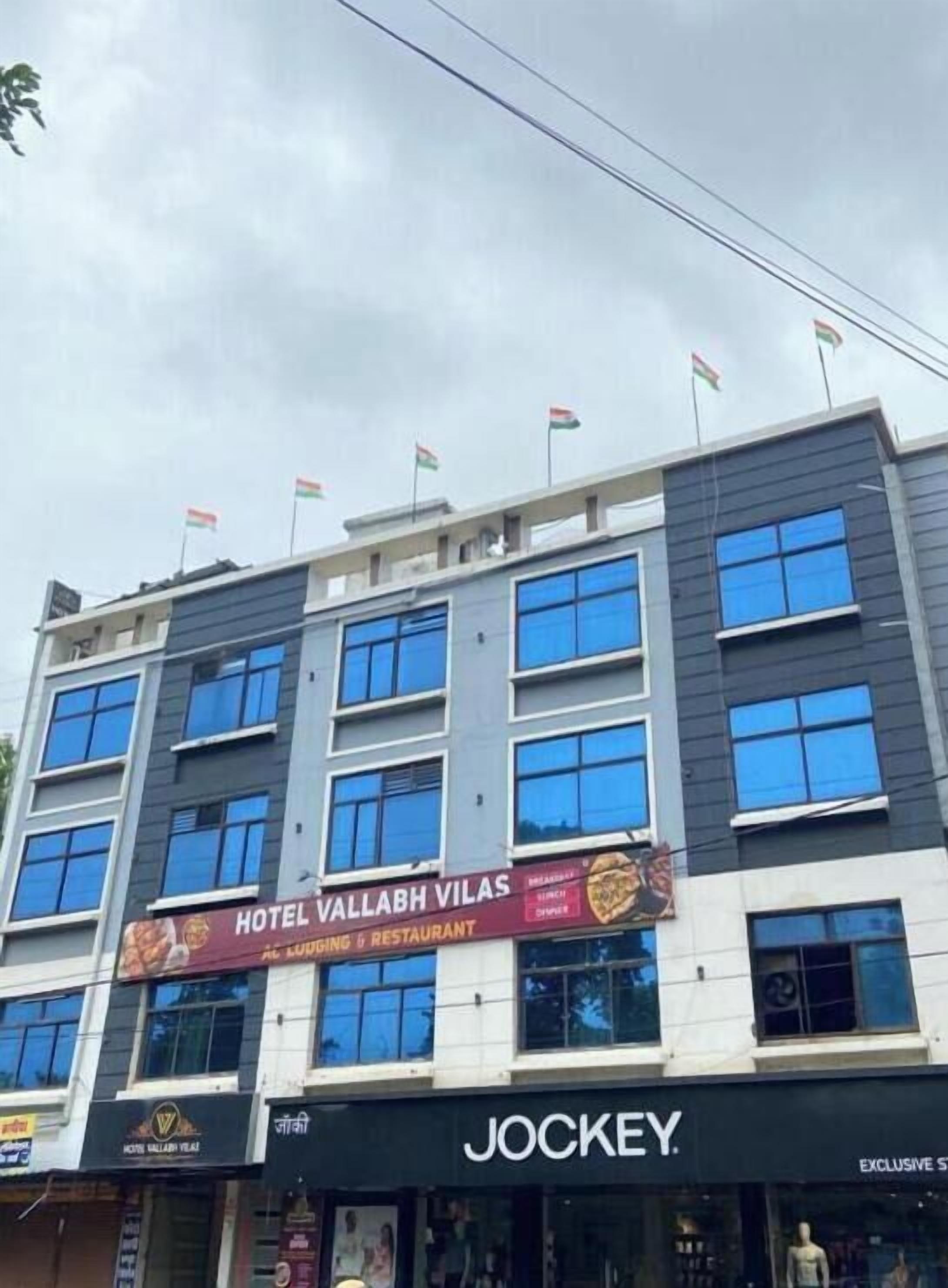 A multi-story building with a restaurant named "Hotel Vallabh Vilas" on the ground floor.