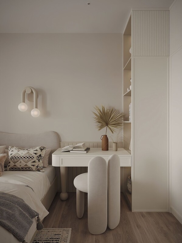 A minimalist bedroom with a bed, bedside table, and a desk with a chair. - The Aura Patong (Patong)