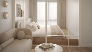 A modern bedroom with a large bed, a sofa, a round table with books, and a view through a glass partition. - The Aura Patong (Patong)