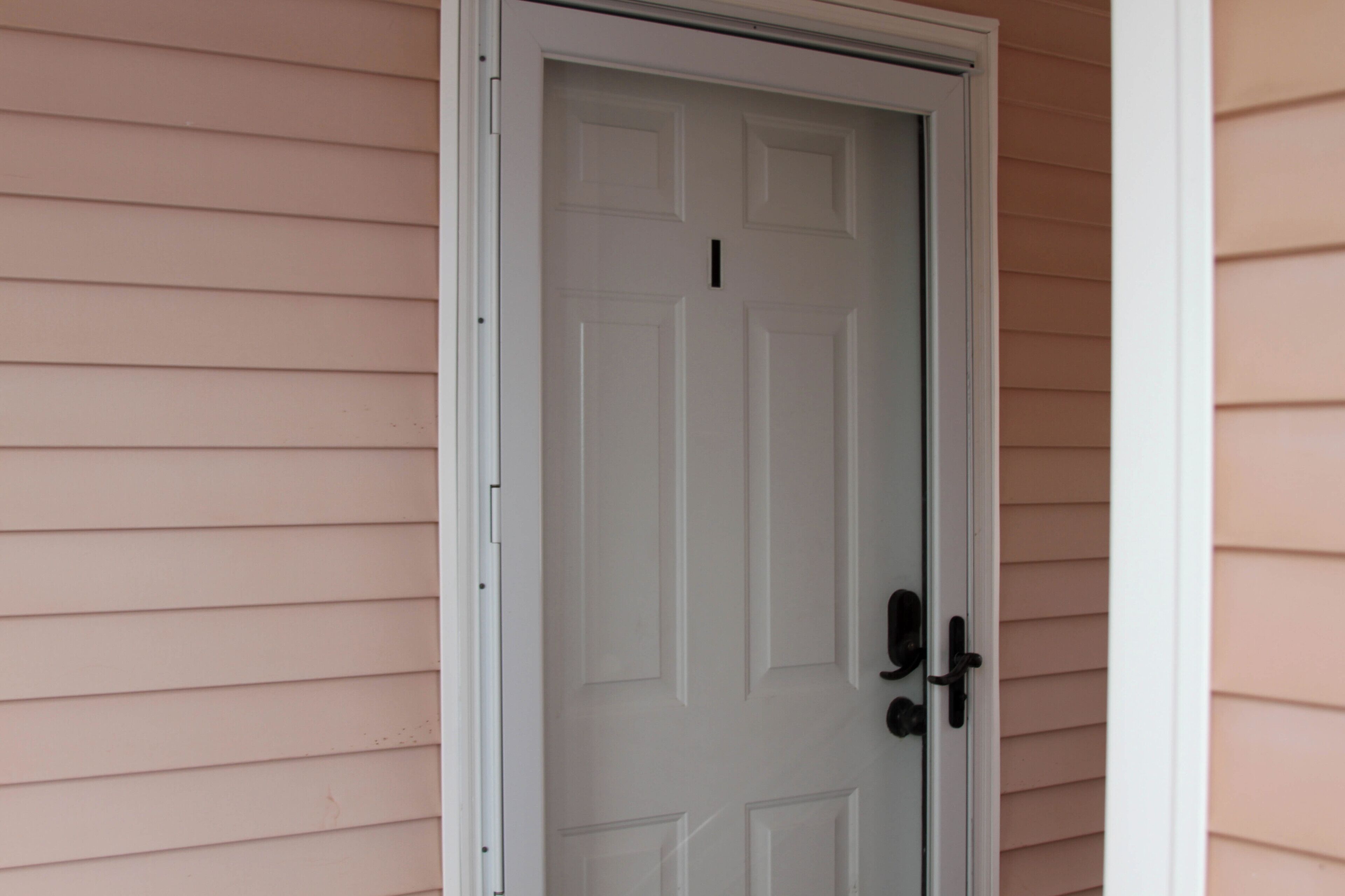 A white door with a black handle and a small black keyhole.