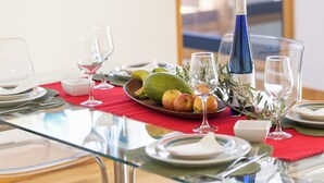 A dining table set with plates, cutlery, glasses, and a bottle of wine. - Villas Mamma Mia  A pool heat Private (Castillo del Aguila)