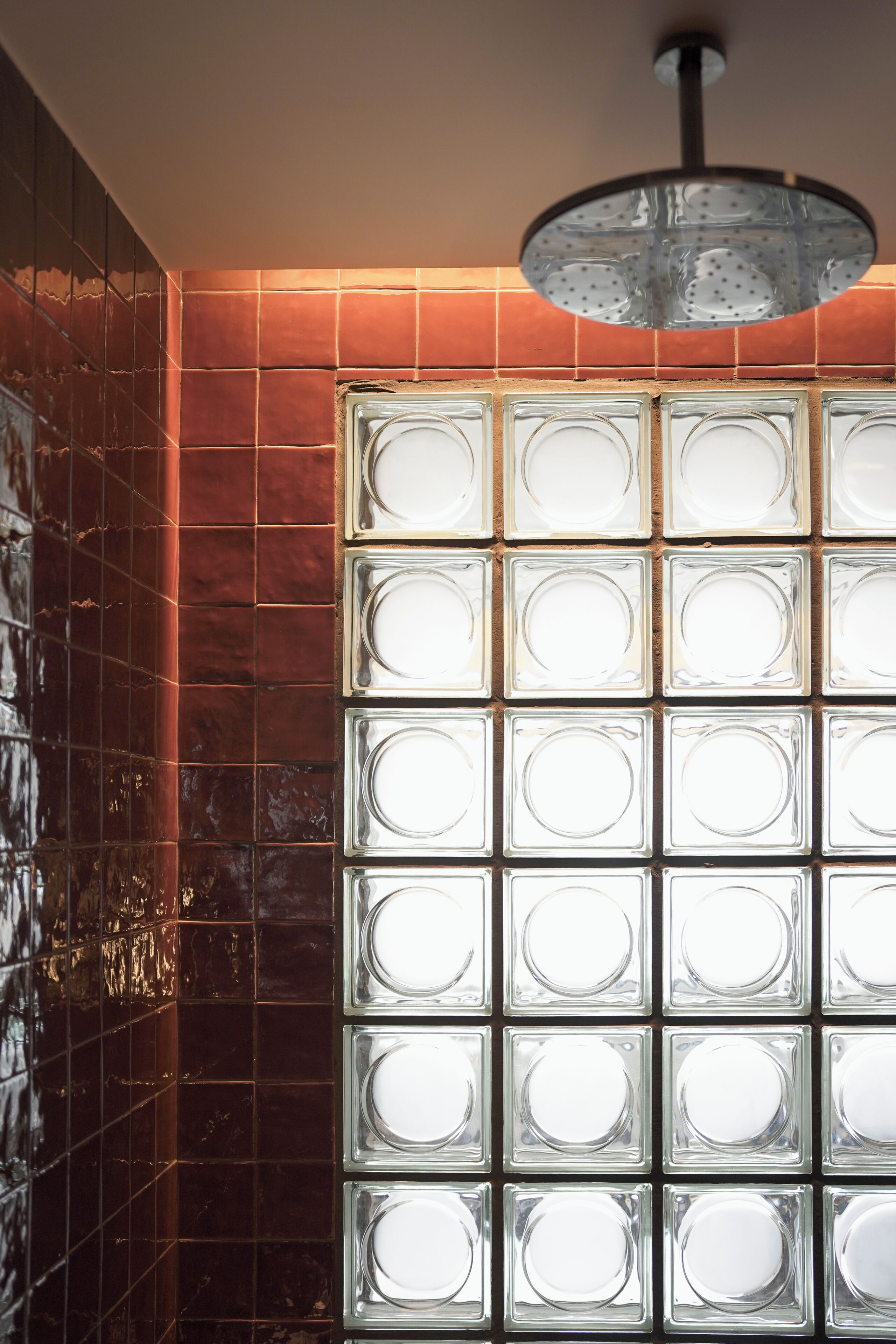 A tiled wall with a series of square windows.