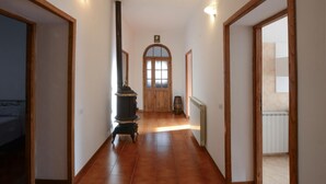 A hallway with wooden doors, a central fireplace, and a radiator. - Lovely home in Santa Fiora (Santa Fiora)