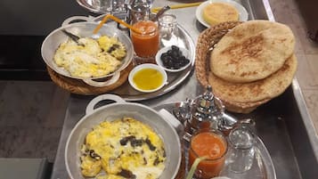 A breakfast buffet with various dishes and condiments.