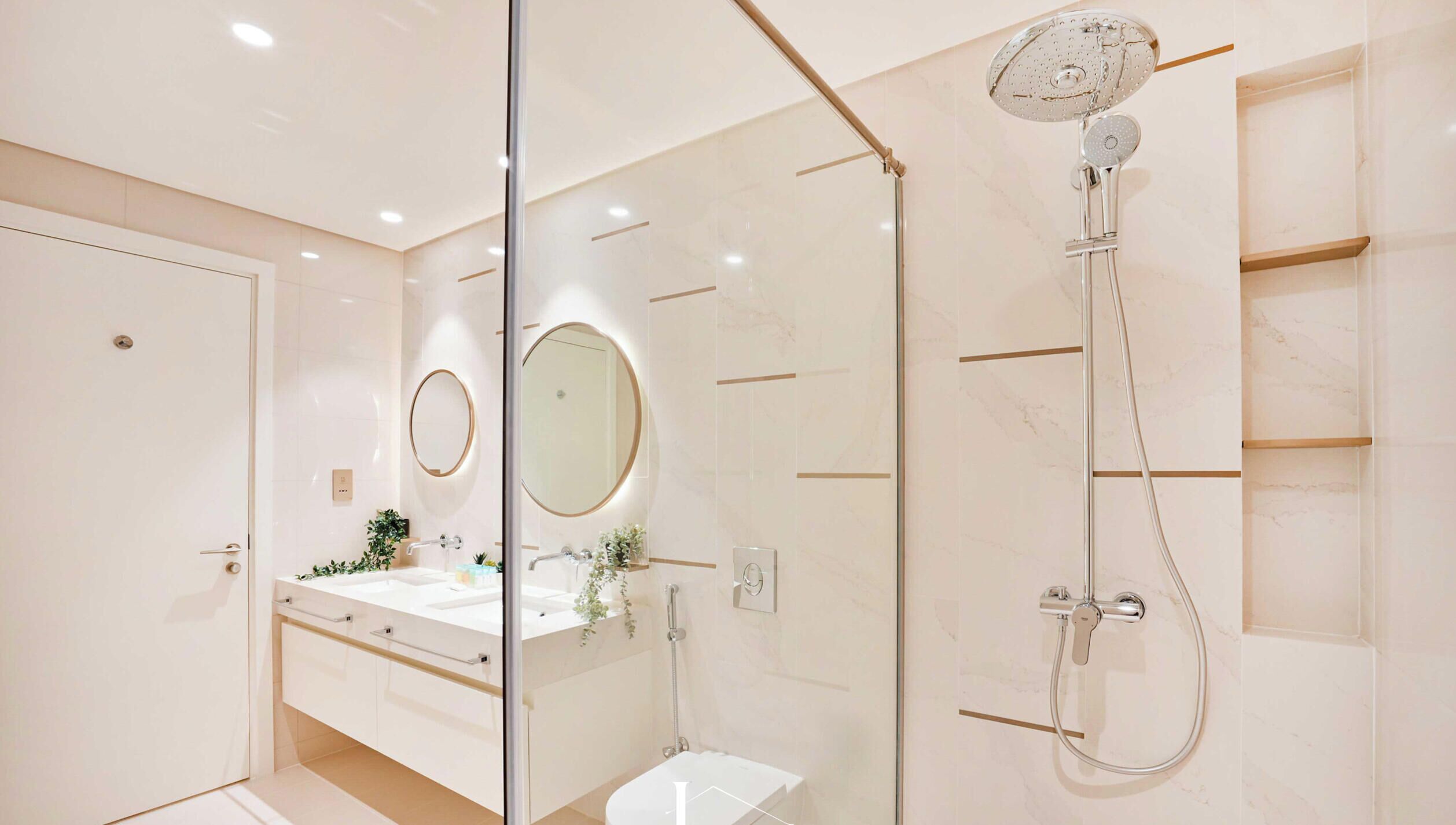 A modern bathroom with a glass shower enclosure, a vanity with a mirror, and a toilet.
