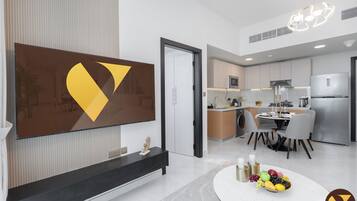 Standard Apartment, 1 King Bed with Sofa bed, Balcony, City View | Living room | 65-inch Smart TV with cable channels