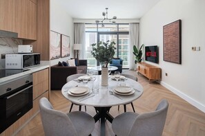 Ein modernes Apartment mit Essbereich, Küche und Wohnraum.