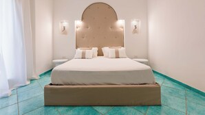 Una camera da letto con un letto grande, due comodini e una testiera con illuminazione integrata.