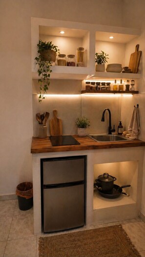 A compact kitchen with a built-in refrigerator, a sink, and a stove. - Farkia Studios - Quadruple By Aegean (Rhodes)