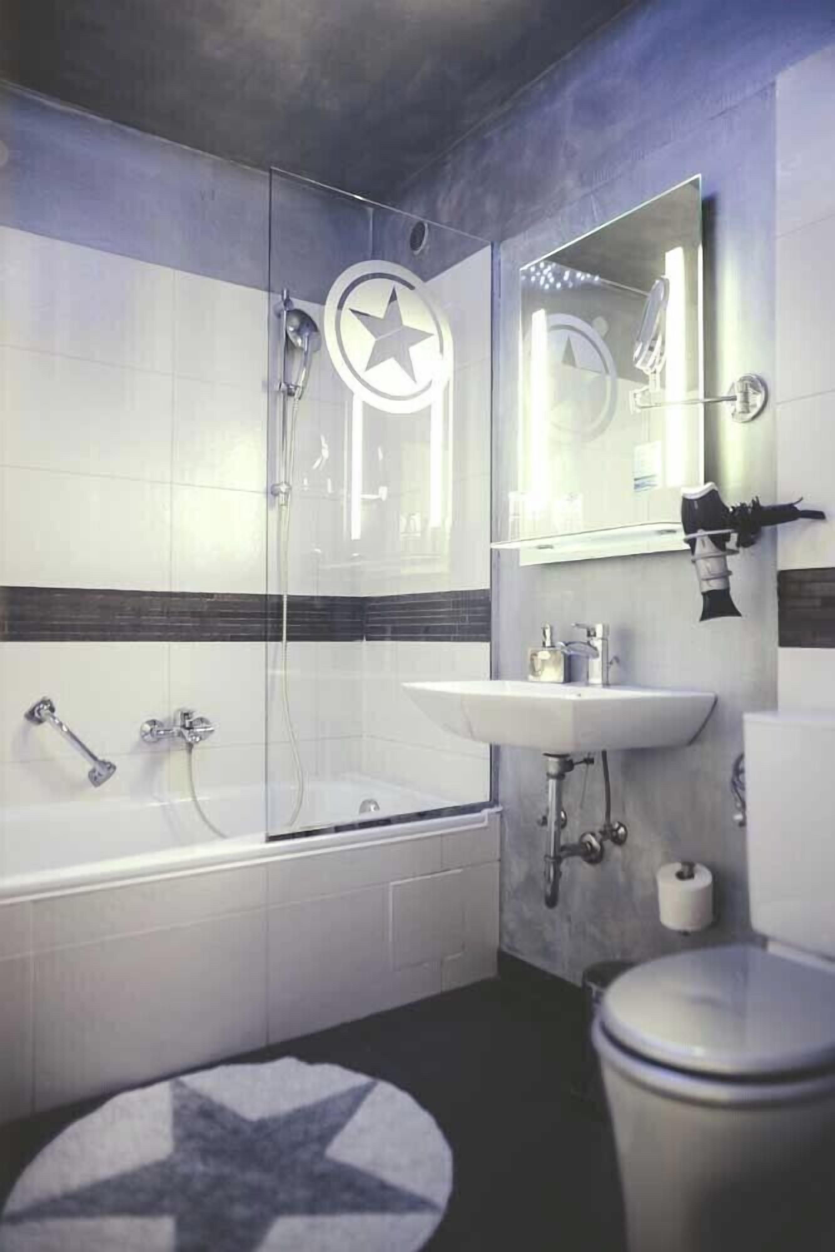 Un baño moderno con bañera, lavamanos e inodoro.