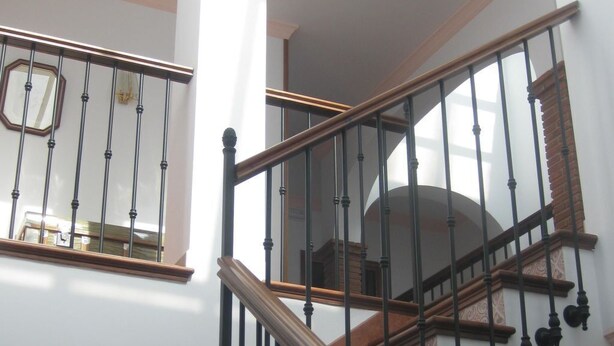 A staircase with wooden steps and black balusters, leading to an upper floor. - "Remedios" mit Terrasse by Interhome (Cuevas del Becerro)