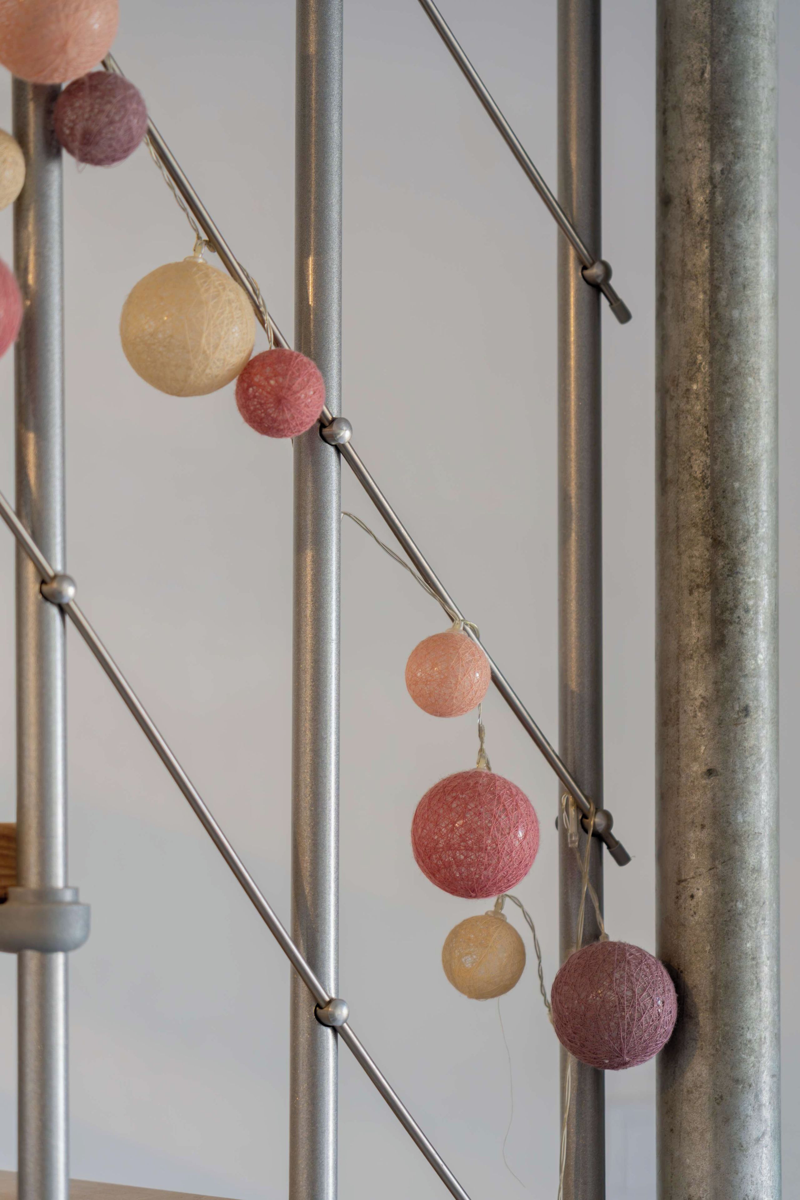 A metal structure with spherical objects attached to it.