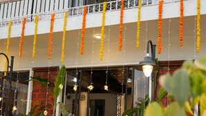 A hotel entrance with a staircase, decorative garlands, and indoor lighting. - Dandeli River Resort (Dandeli)