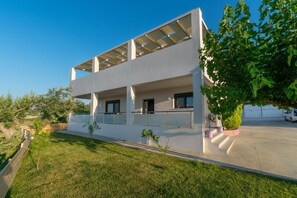 A modern two-story building with a flat roof, large windows, and a covered outdoor area. - Alkistis Villa with amazing sea view (9G4V+4G2 Rethymno, Greece)
