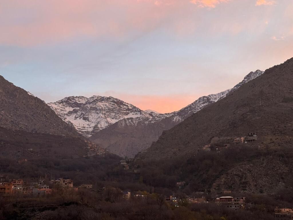 A mountainous landscape with buildings nestled in the valley.
