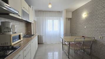 Basic Apartment, Balcony, City View | Private kitchen | Coffee/tea maker, electric kettle, dining tables