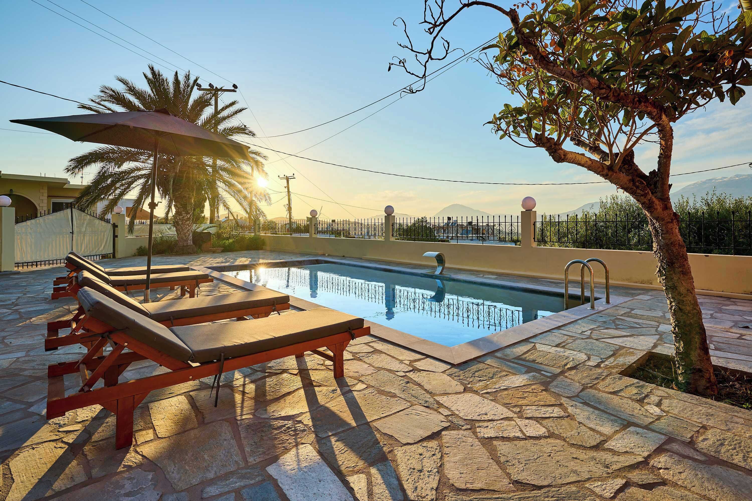 Stunning villa exterior at night with a glowing pool, perfect for evening relaxation