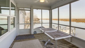 A covered outdoor area with a table and a view of a body of water. - Waterfront NOLA Gem w/ Boat Dock & Lift on Wildlife Refuge (New Orleans)